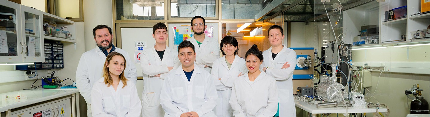 Team of researchers standing together in a modern laboratory environment.